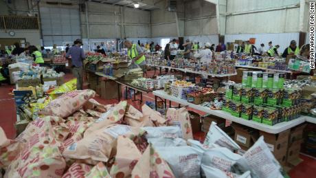 Food, clothes and other supplies are organized at a supply center in Mayfield on December 15.