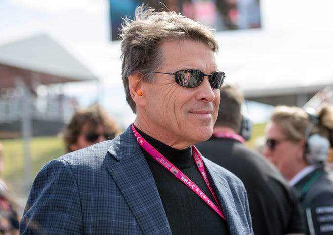 Nov 2, 2014; Austin, TX, USA; Texas former governor Rick Perry walks the starting grid before the 2014 U.S. Grand Prix at Circuit of the Americas.