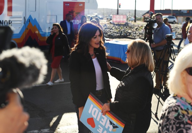 Republican Heidi Ganahl, center, speaks with ...