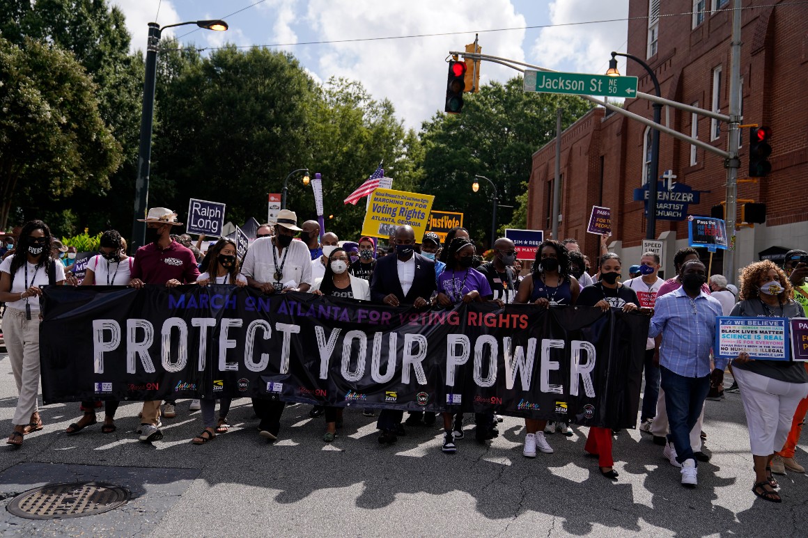 Demonstrators holds a sign during a march for voting rights, marking the 58th anniversary of the March on Washington, on Aug. 28, 2021, in Atlanta. 