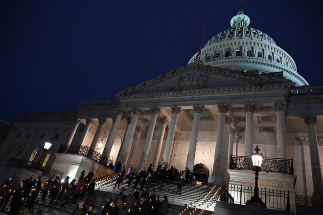US lawmakers take part in a prayer vigil on the first anniversary of the assault on the US Capitol, on the East Steps of the Capitol in Washington, DC on January 6, 2022.