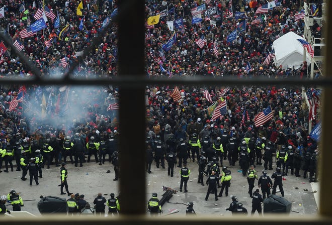 Police hold back supporters of US President Donald Trump as they gather outside the US Capitol's Rotunda on January 6, 2021, in Washington, DC. - Demonstrators breeched security and entered the Capitol as Congress debated the a 2020 presidential election Electoral Vote Certification.