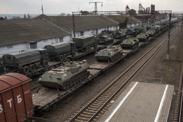 Military trucks and personnel carriers were loaded to the train car outside Taganrog, Russia, today.