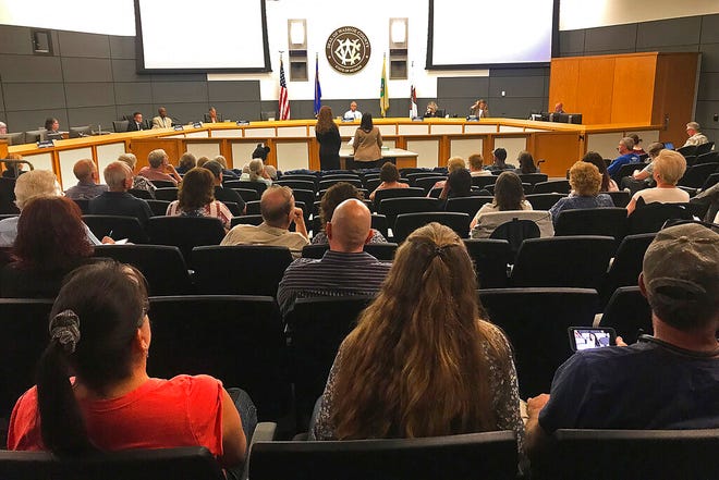 Members of the audience watch Washoe County Government Affairs Manager Jaime Rodriguez, and Assistant Registrar of Voters Heather Carmen speak during a county Board of Commissioners meeting called in Reno, Nev., on Friday, June 24, 2022, to certify the vote of the June 14, 2022, primary.