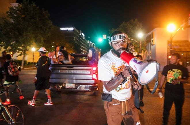 Chris Wells helps lead a protest march on South Second Street in downtown Louisville on Tuesday, July 21, in honor of Breonna Taylor as well as seek justice for her shooting. Taylor was fatally shot by three LMPD plainclothes officers who were attempting to serve a "no-knock" search warrant at 12:40 a.m. The protestors have still occupied Jefferson Square during the daytime hours and up to 11 p.m. for the past 54 days.