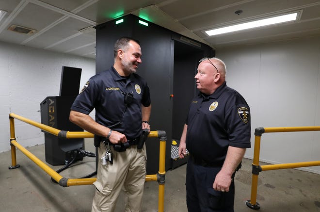 New Louisville Metro Department of Corrections Director Jerry Collins, right, talks with Capt. Jason Logsdon inside the facility in Louisville, Ky. on Sept. 14, 2022. Under his leadership, the department is attempting to improve the culture after a series of issues and inmate deaths over the past few years.