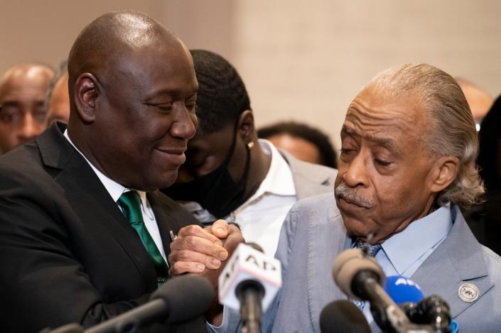 Mr Crump, left, with Reverand Al Sharpton at a news conference after former Minneapolis police Officer Derek Chauvin was convicted in the George Floyd killing (AP)