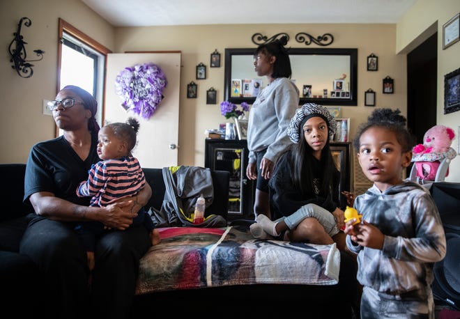 Lataki Truitt, left, holds her granddaughter KCI MInor, while Darrielle Jones walks past. In black is Jarionna Jones and on right is Dearrie Minor. KCI and Dearrie are Prissy Jones's daughters. Prissy Jones, the daughter of Lataki Truitt, was killed in a domestic violence incident this past summer. Oct, 6, 2022