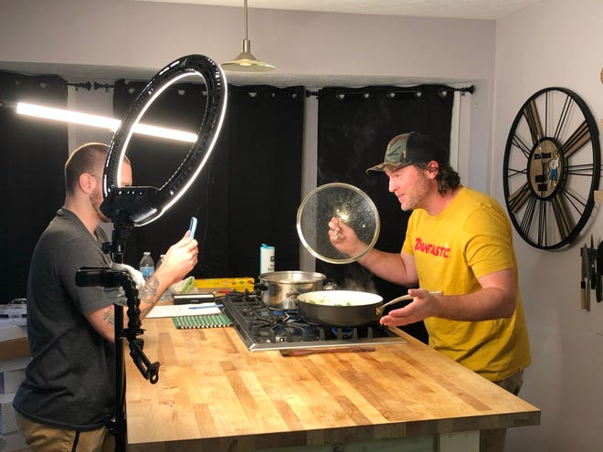 Dan Oliver, founder of Dan-O's Seasoning making a Tik Tok video in his kitchen.