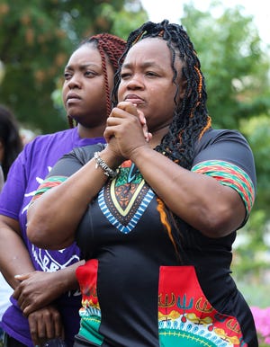 Tamika Palmer, right, and her sister Bianca Austin listened to speakers at Jefferson Square Park following the announcement that the police officers involved in the killing of Breonna Taylor will face federal charges in Louisville, Ky. on Aug. 4, 2022. Palmer is Taylor's mother.