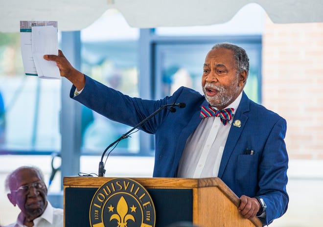 Sen. Gerald Neal, D-Louisville, speaks while Manfred Reid listens at the phase three opening of Beecher Terrace in Louisville, Ky. on July 21, 2022.